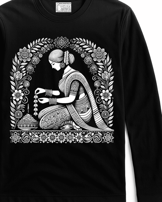 Malini Alpona Art T-shirt features intricate Bengali folk art of a woman creating Alpona, printed in white on a black full sleeves cotton tee. Unisex fit ideal for cultural fashion lovers.