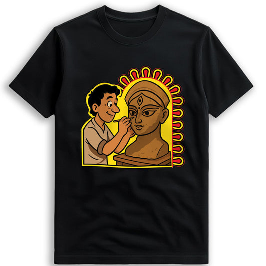 Idol Maker T-shirt close-up — Kumartuli artisan painting the eyes onto a Durga idol, illustrated tribute on black cotton