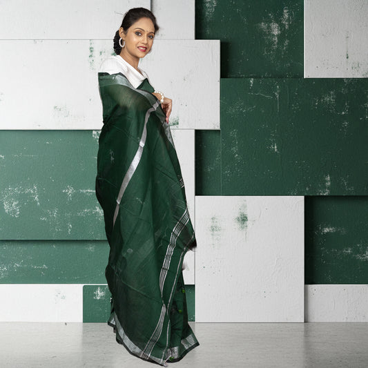 Back view of heritage green Kumorparar Gorur Gari cotton saree showcasing its breathable texture and minimalist silver border design.
