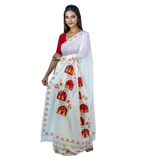 Woman in a red blouse wearing the Pujo Scroll khadi saree, angled view showing the scroll-style Durga Puja scene panels down the pallu and the lotus-and-line border