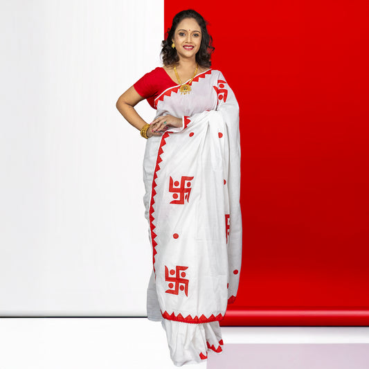 Traditional white and red Swastik Shubha cotton saree featuring sacred Swastika symbols, perfect for Durga Puja and ceremonial wear.