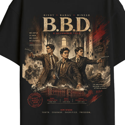 Close-up of B.B.D. tribute tee print detail showing Binoy, Badal, Dinesh portrait illustration, Writers' Building corridor scene, and name plaques with dates