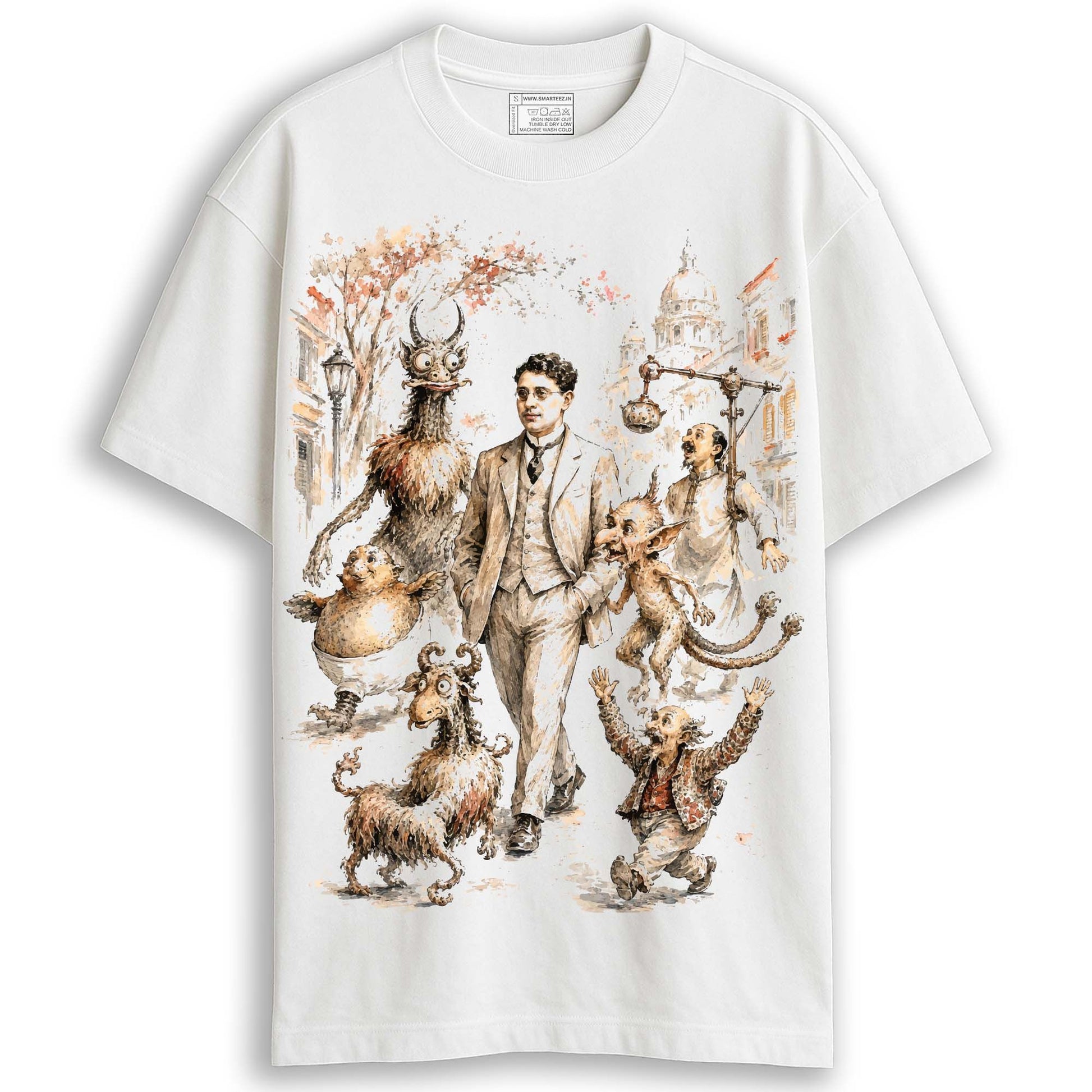 White Abol Tabol oversized T-shirt with Sukumar Ray nonsense creature illustration, feature callouts showing 100% cotton and drop-shoulder fit