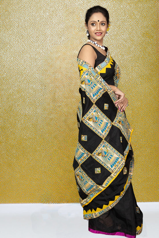 Side view of Heritage Bangaliyana Appliqué Saree in black cotton, adorned with vibrant folk motifs and yellow accents for festive styling.