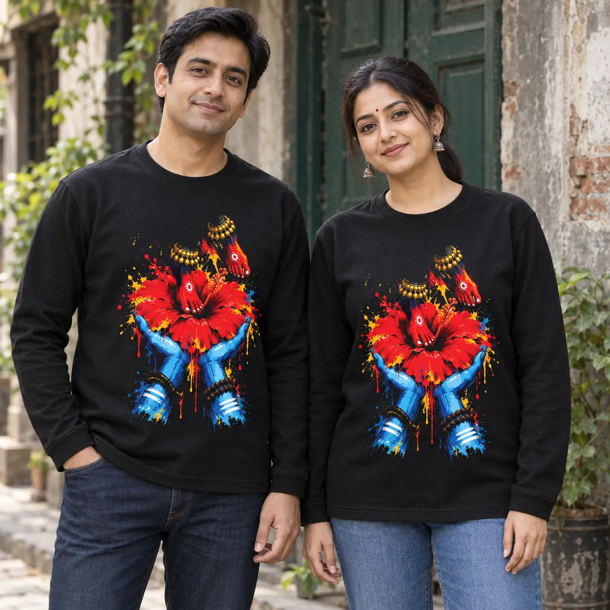 Man and woman wearing matching black Mon Keno Mayer Charanchara full sleeves T-shirts with red hibiscus artwork, unisex fit