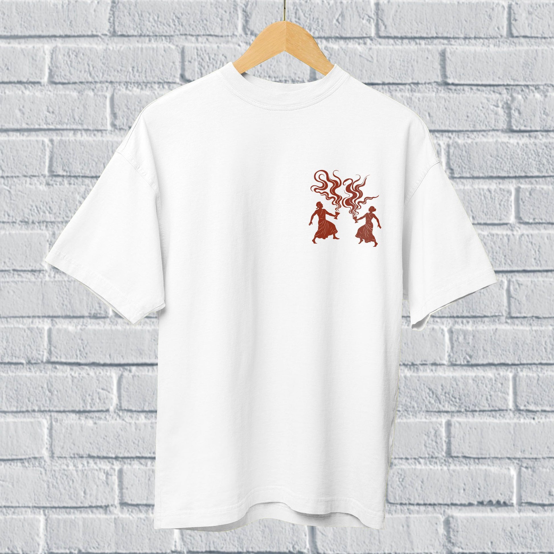 White oversized unisex Dhunuchi Dance Tee featuring minimal folk design of Durga Puja dancers in red. Ideal for celebrating Bengal's festive spirit.