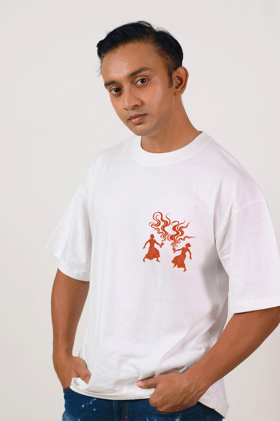 Unisex oversized Dhunuchi Dance Tee for Durga Puja featuring minimal folk design in red on white cotton fabric. Ideal for festive cultural wear.
