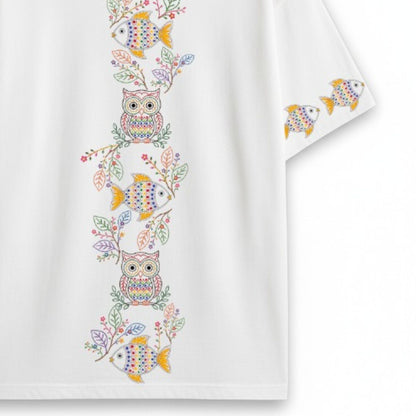 Back view flat lay of Owl & Fish oversized T-shirt showing vertical Kantha-inspired embroidery-style column of owls, fish, and floral branches