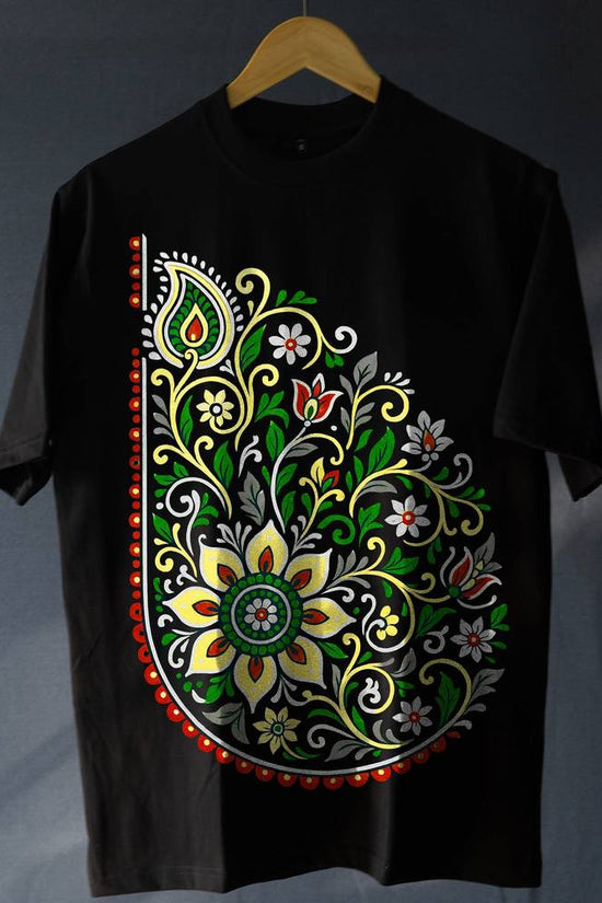 Unisex Folk Art T-Shirt - Oversized Style | 100% Cotton featuring vibrant floral paisley design in red, green, and yellow on black fabric. Ideal for modern boho fashion lovers seeking comfort and tradition.