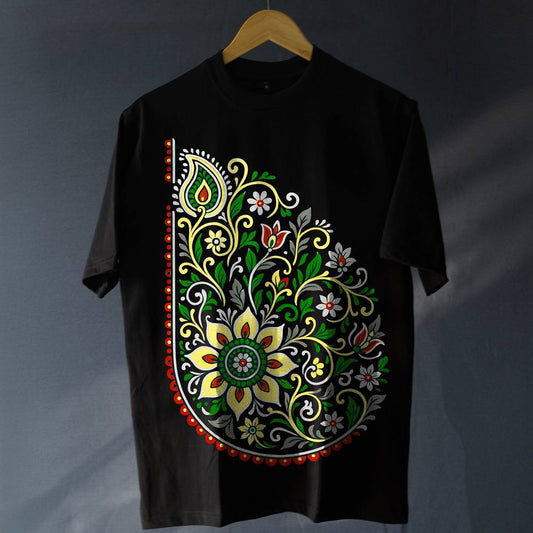 Unisex Folk Art T-Shirt - Oversized Style | 100% Cotton featuring vibrant floral paisley design in red, green, and yellow on black fabric. Ideal for modern boho fashion lovers seeking comfort and tradition.