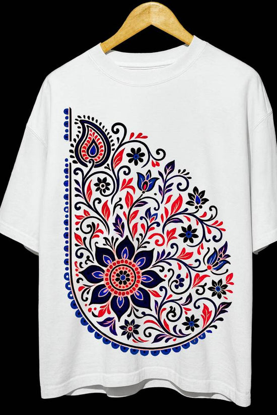 Unisex Folk Art T-Shirt in oversized fit featuring vibrant floral paisley design in red, blue, and black on white 100% cotton fabric. Ideal for casual wear.