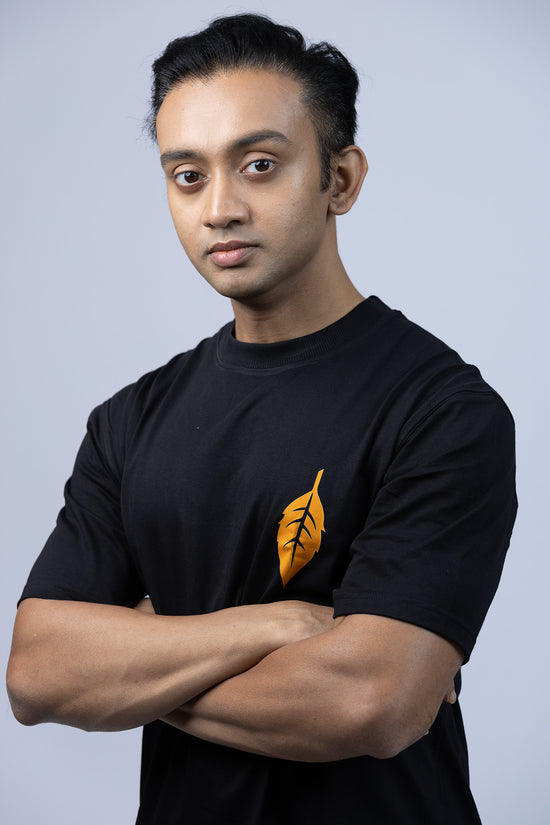 Front view of 'Ami Dhowa Tulsi Pata' oversized Bengali graphic T-shirt featuring a minimalistic leaf design. A must-have for casual streetwear lovers.