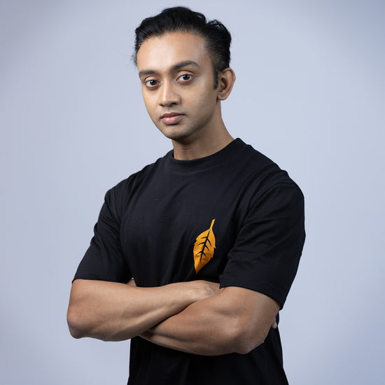 Front view of 'Ami Dhowa Tulsi Pata' oversized Bengali graphic T-shirt featuring a minimalistic leaf design. A must-have for casual streetwear lovers.