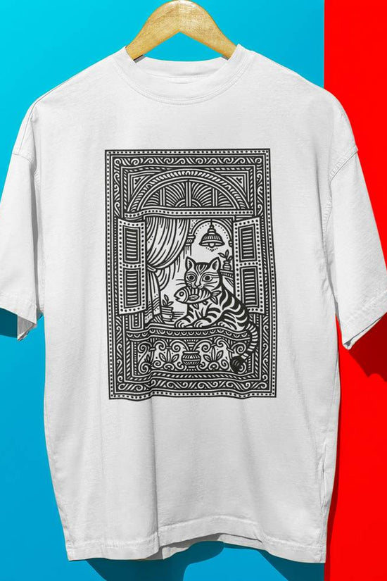 Ghorer Bagh Cat Art T-Shirt - Unisex Bengali Style featuring black heritage cat illustration in window frame on oversized white tee.
