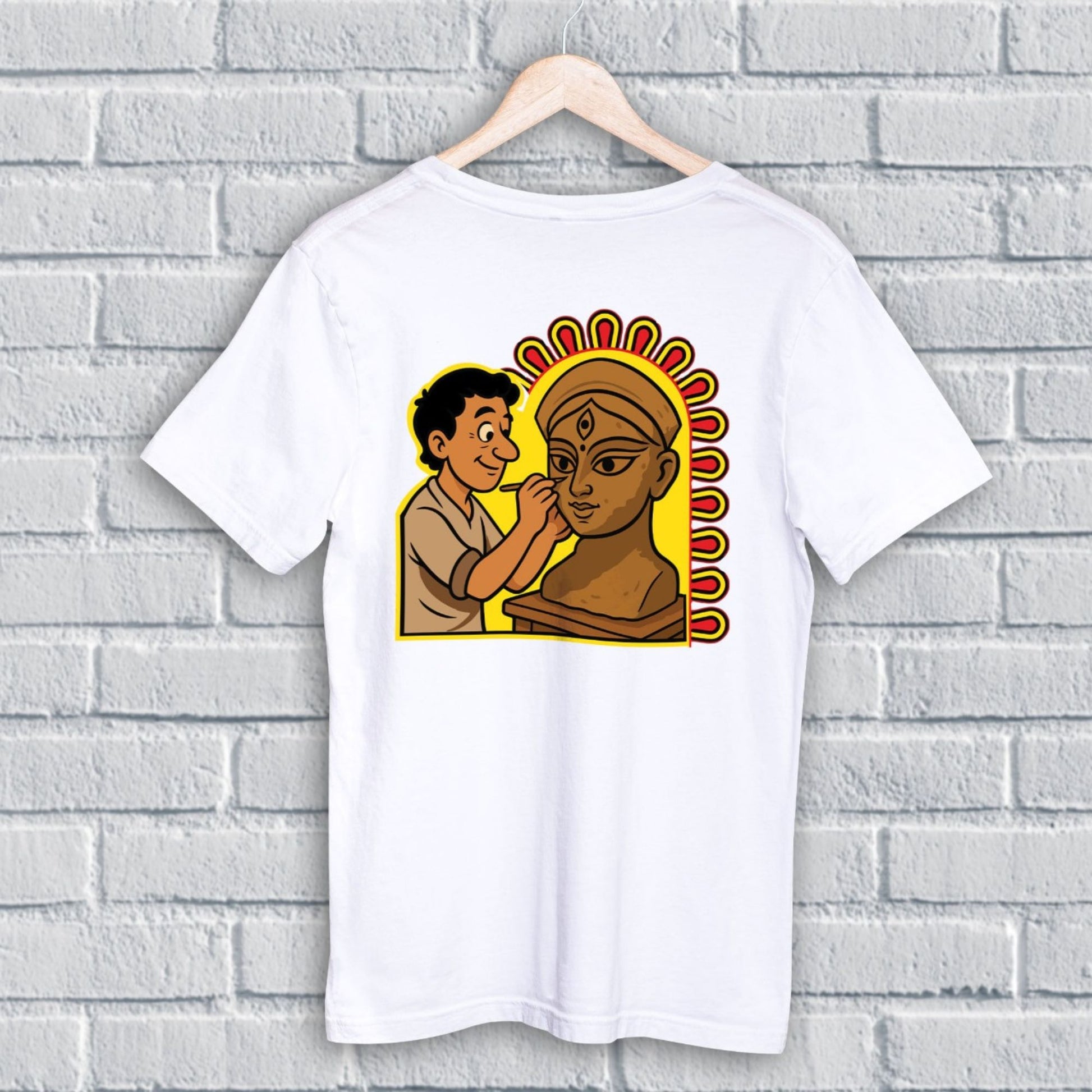 Durga Puja T-Shirt - Artistic Tribute | Premium Cotton, Unisex. Features cartoon-style idol maker painting Goddess Durga, celebrating Kumartuli artisans.