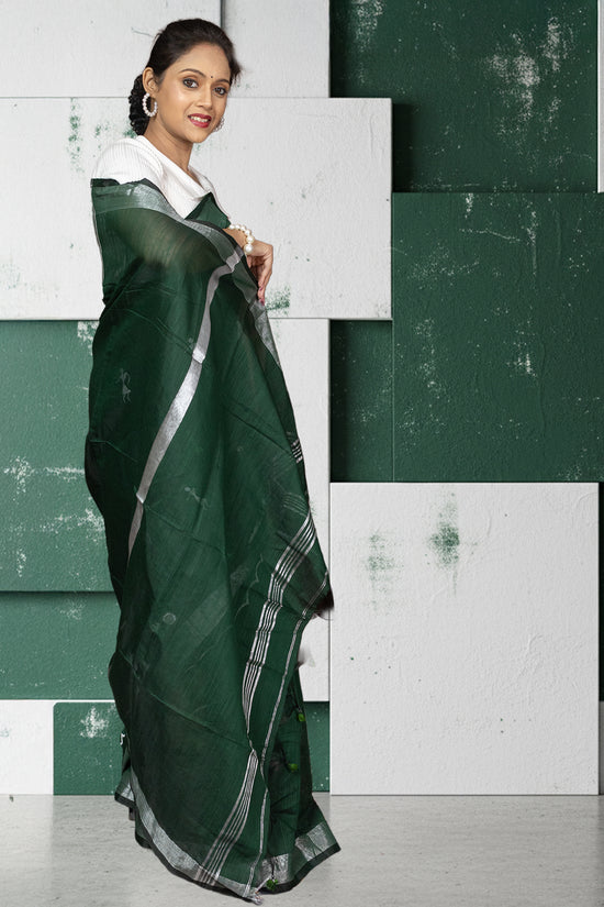 Back view of heritage green Kumorparar Gorur Gari cotton saree showcasing its breathable texture and minimalist silver border design.