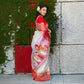 Heritage cotton saree with bold Durga Puja ritual artwork, blending comfort and tradition in a red-bordered ceremonial sari.