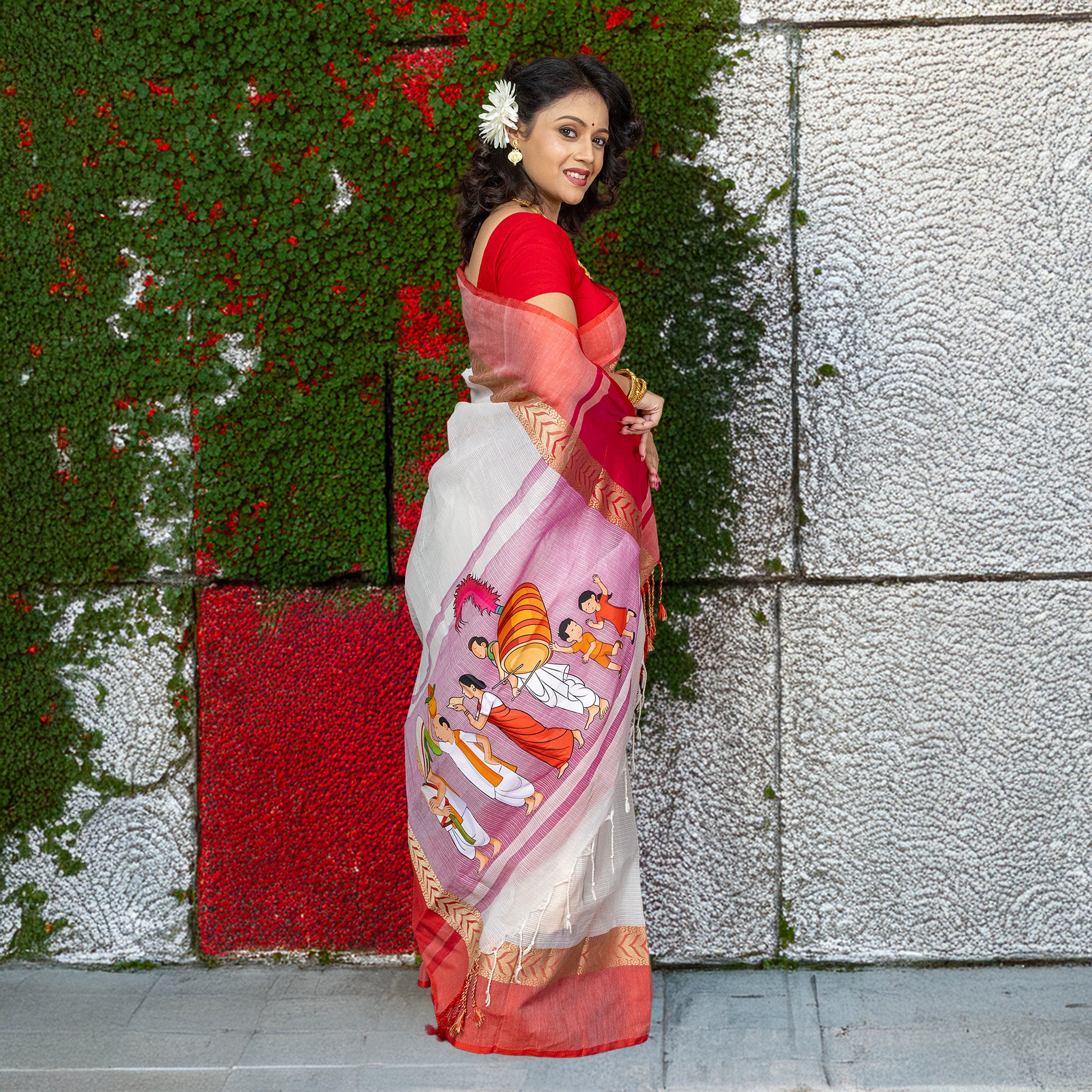 Heritage cotton saree with bold Durga Puja ritual artwork, blending comfort and tradition in a red-bordered ceremonial sari.
