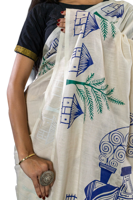 Pather Panchali Saree - Pure Khadi Cotton close-up of intricate blue house and green palm motifs, hand-printed on soft beige cotton.