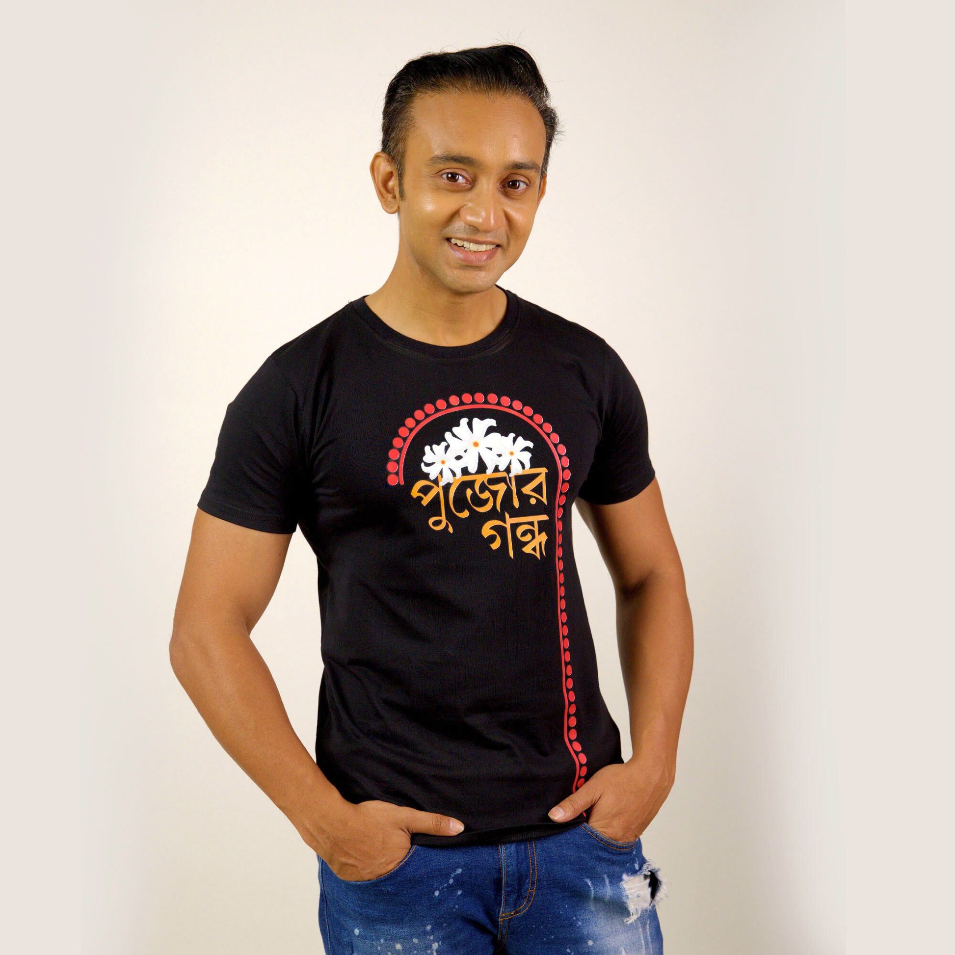Durga Puja T-Shirt - Pujor Gondho in black with Bengali typography and sheuli flower design, unisex regular fit for festive wear.