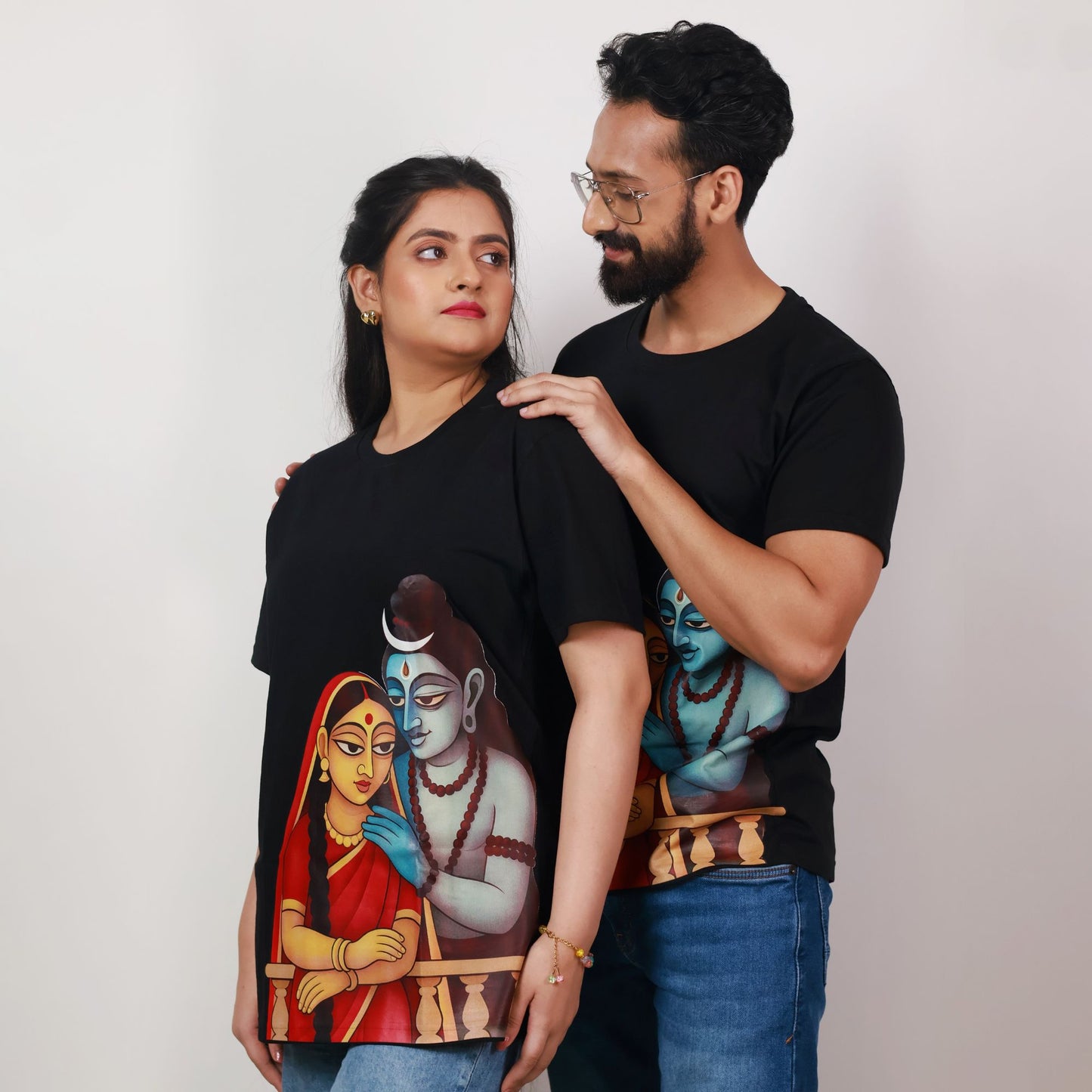 Couple wearing matching Shiva-Parvati Tee - Maa Durga T-Shirts, showcasing Bengali art and celebrating feminine strength and tradition.