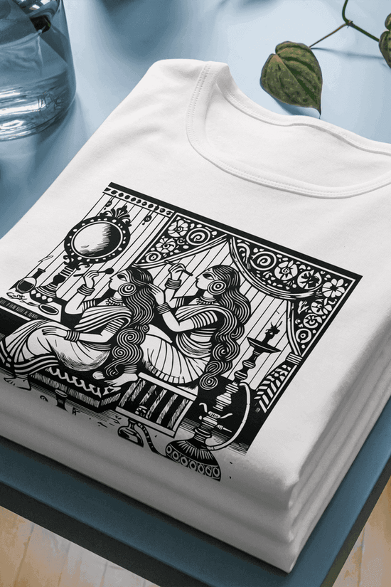 Kalighat Patachitra style T-shirt featuring intricate black folk art print on soft white cotton fabric, celebrating Bengal’s traditional artistry.