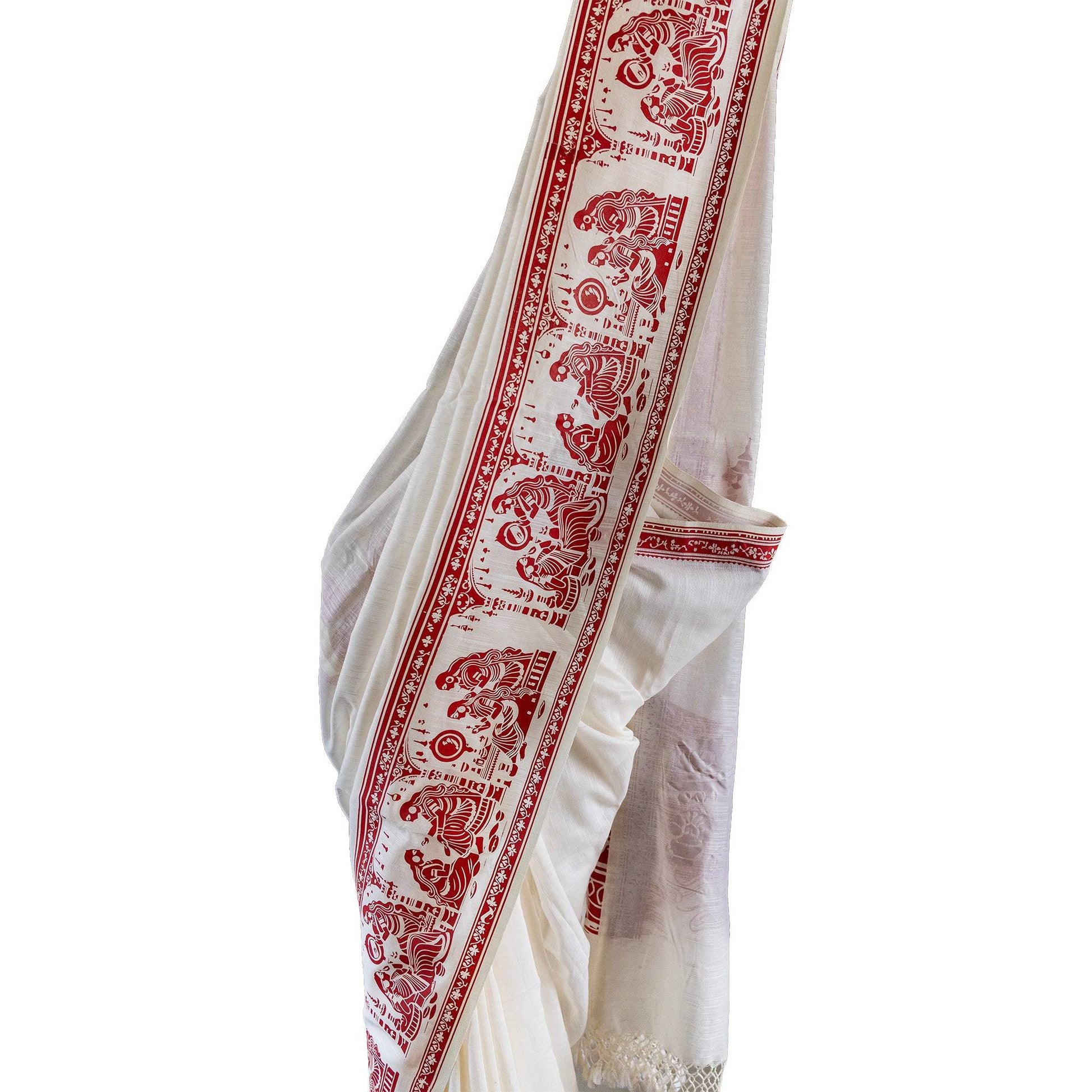 Sringer red on white printed khadi cotton saree featuring Kalighat Patachitra motifs along the border. Ideal for traditional and cultural wear.