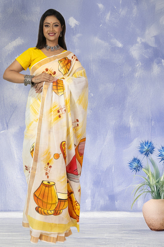 Hand-painted Sur Taal Kerala Cotton Saree featuring vibrant musical instrument designs, ideal for festive and ceremonial wear.