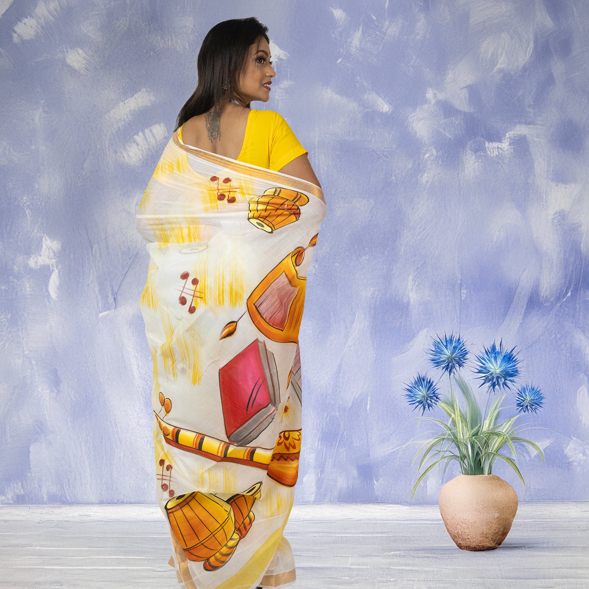 Back view of Sur Taal Saree showcasing detailed hand-painted musical elements on soft Kerala cotton, suited for cultural festivities.