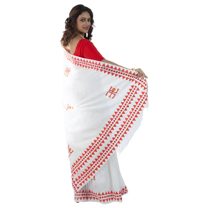 Durga Puja saree pallu draped over shoulder showing Swastik motif and triangular folk art border on khadi cotton