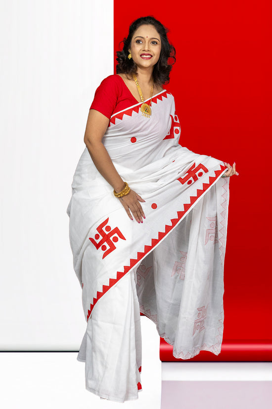 Elegant Swastik Shubha saree with bold red Swastika motifs and geometric border, crafted in breathable cotton for festive occasions.