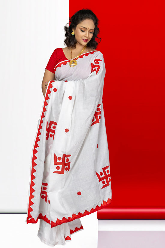 White cotton Swastik Shubha saree adorned with red Swastika appliqué and dotted accents, suitable for weddings and religious events.