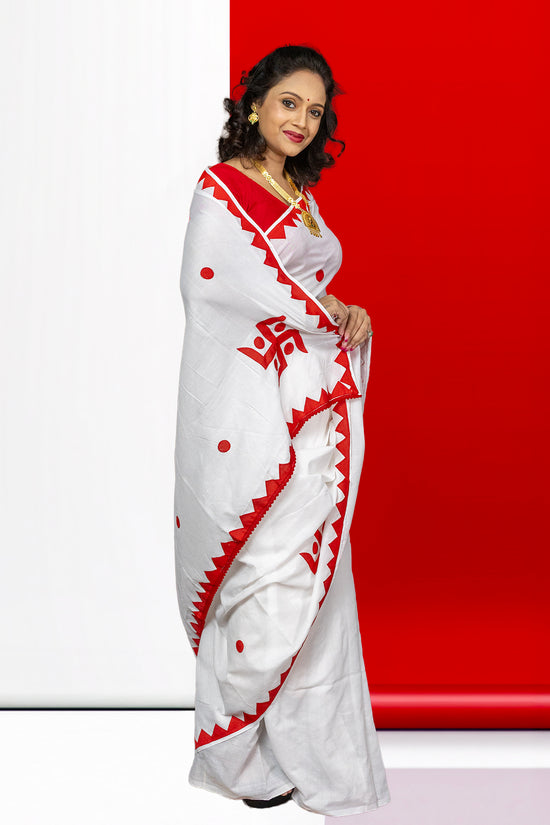 Swastik Shubha cotton saree in festive white and red, featuring sacred Swastika motifs and traditional design for ceremonial attire.