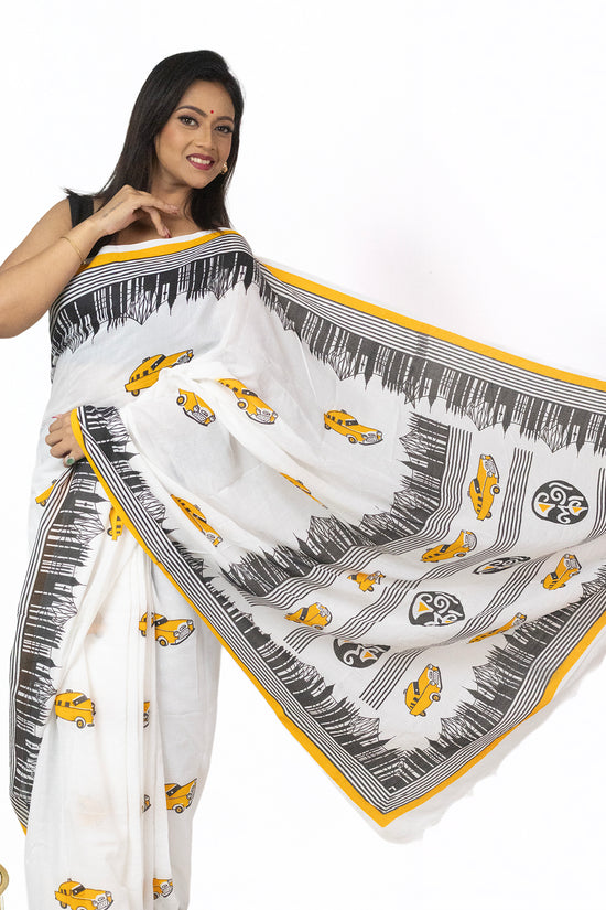 Kolkata Theme Cotton Saree in white with yellow taxi motifs and black cityscape border, ideal for festive wear and Bengali cultural celebrations.