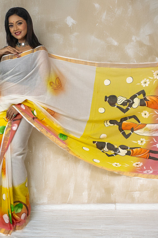 Tribal Tales - Hand Painted Saree in Kerala cotton featuring vibrant tribal folk art on pallu, ideal for festive and cultural occasions.