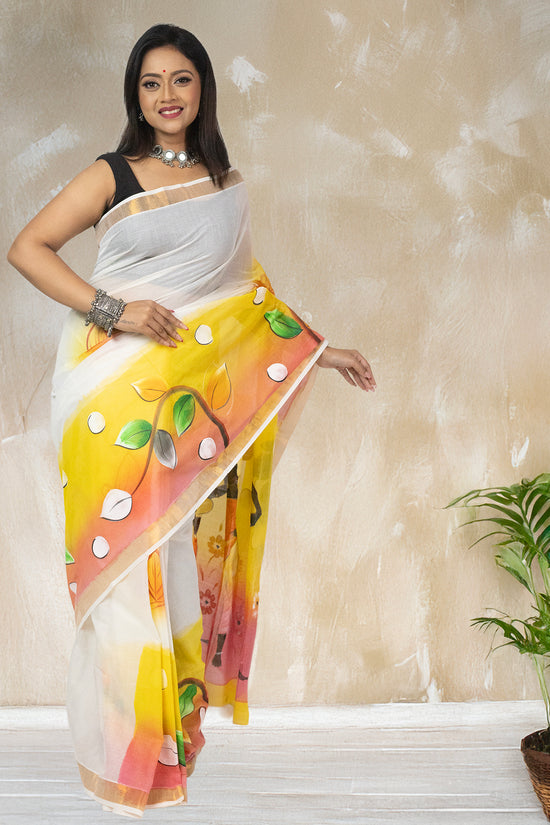 Elegant Tribal Tales hand-painted Kerala cotton saree with leaf and dot patterns, blending folk art with contemporary ethnic fashion.