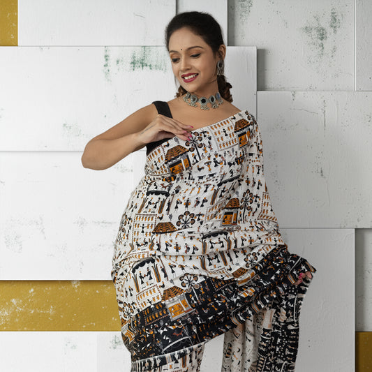 Warli Tales Saree - Tribal Art Cotton draped elegantly, showcasing intricate Warli folk motifs in earthy tones. Ideal for festive ethnic wear.