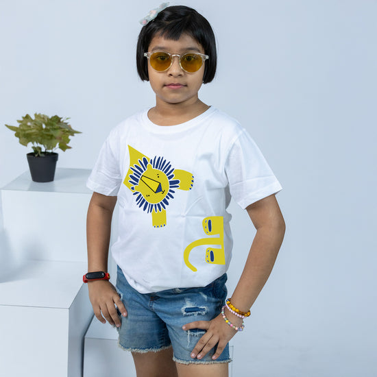 White kids' T-shirt featuring a vibrant yellow and blue lion print, paired with denim shorts. Perfect for casual wear.