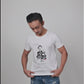 Model showcasing a white unisex T-shirt with a Kishore Kumar graphic design in Bengali script, paired with casual denim jeans.