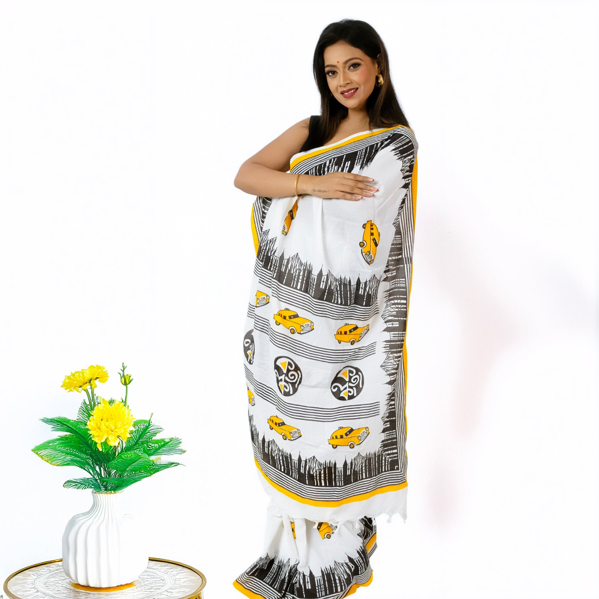 Kolkata Theme Cotton Saree in white with yellow taxi motifs and hand-painted cityscape, perfect for festive wear and Bengali cultural celebrations.